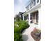 Inviting front porch with white columns, seating, and lush landscaping creating a cozy outdoor space at 2245 Meadow Crk, Avon, IN 46123