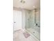 Modern shower with glass door, tiled walls, and a built-in niche, complemented by neutral-toned flooring at 2245 Meadow Crk, Avon, IN 46123