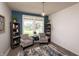 Cozy sitting room with hardwood floors, neutral-toned walls, bookshelves, and a pair of comfortable armchairs at 2245 Meadow Crk, Avon, IN 46123