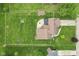 Aerial view of the property showcasing the home, backyard, patio, and surrounding landscape at 2303 Alexandria Dr, Greenfield, IN 46140