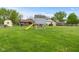 Spacious backyard with a playhouse, storage shed, and ample green space at 2303 Alexandria Dr, Greenfield, IN 46140