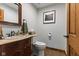 Bathroom featuring wood floors, a marble countertop vanity, and a framed silhouette wall art at 2303 Alexandria Dr, Greenfield, IN 46140