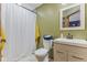 Bright bathroom with a modern vanity, white toilet, and shower with a white curtain at 2303 Alexandria Dr, Greenfield, IN 46140