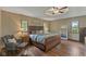 Bedroom featuring wood-look flooring, ceiling fan, decor and furniture, and large windows at 2303 Alexandria Dr, Greenfield, IN 46140