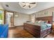 Bedroom featuring wood-look flooring, ceiling fan, decor and furniture, and adjoining doorway at 2303 Alexandria Dr, Greenfield, IN 46140