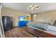 Bedroom with furniture, tv, wood-look flooring, and adjoining door leading to bathroom at 2303 Alexandria Dr, Greenfield, IN 46140
