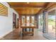 Dining room with wood walls and ceiling with large wood table and patio doors at 2303 Alexandria Dr, Greenfield, IN 46140