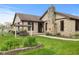 Charming ranch home featuring a stone chimney and a garden in a well-manicured front yard at 2303 Alexandria Dr, Greenfield, IN 46140