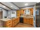 Well lit kitchen boasts stainless steel appliances, granite counters, and backsplash tile at 2303 Alexandria Dr, Greenfield, IN 46140