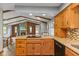 Open kitchen to the living room with stone fireplace, granite counters, and hardwood floors at 2303 Alexandria Dr, Greenfield, IN 46140