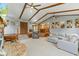 Open-concept living room with stone fireplace, vaulted ceilings, and seamless flow to the kitchen at 2303 Alexandria Dr, Greenfield, IN 46140
