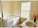 Bathroom with a soaking tub, natural light, and double sinks at 2444 Cole Branch Ct, Indianapolis, IN 46239