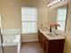 Bright bathroom with double vanity, large mirror, and a tiled jacuzzi tub at 2444 Cole Branch Ct, Indianapolis, IN 46239