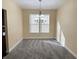 Cozy dining area with neutral walls, plush carpeting, and an elegant chandelier for ambient lighting at 2444 Cole Branch Ct, Indianapolis, IN 46239
