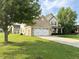 Lovely two-story home with a two-car garage, brick accents, and a well-maintained lawn and landscaping at 2444 Cole Branch Ct, Indianapolis, IN 46239