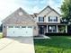 Charming two-story home featuring a brick and siding facade, well-manicured lawn, and a two-car garage at 2444 Cole Branch Ct, Indianapolis, IN 46239