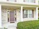 Inviting front porch with brick facade, columns and lovely landscaping at 2444 Cole Branch Ct, Indianapolis, IN 46239