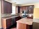 Well-equipped kitchen featuring wooden cabinets, stainless steel appliances, and ample counter space at 2444 Cole Branch Ct, Indianapolis, IN 46239