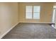 Bright living room with neutral walls, plush carpeting, and a large window offering natural light at 2444 Cole Branch Ct, Indianapolis, IN 46239