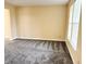 Bright living room with neutral walls, plush carpeting, and a large window offering natural light at 2444 Cole Branch Ct, Indianapolis, IN 46239