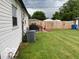 View of the backyard featuring a patio set, well-maintained lawn, and perimeter fence at 2650 Woodrow Ave, Indianapolis, IN 46241