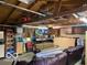 Garage featuring exposed beams, storage shelves, and seating area, offering versatile space at 2650 Woodrow Ave, Indianapolis, IN 46241