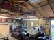 Garage featuring exposed beams, storage shelves, and a seating area, offering versatile space at 2650 Woodrow Ave, Indianapolis, IN 46241