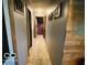 Hallway featuring neutral tones, wood trim, and an area rug, leading to rooms within the home at 2650 Woodrow Ave, Indianapolis, IN 46241