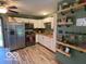 Well-lit kitchen with white cabinets, stainless steel appliances, and a modern aesthetic at 2650 Woodrow Ave, Indianapolis, IN 46241