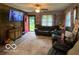 Comfortable living room with a TV, area rug, and open to the front entryway at 2650 Woodrow Ave, Indianapolis, IN 46241