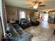 Cozy living room with a ceiling fan, dark leather furniture and natural light at 2650 Woodrow Ave, Indianapolis, IN 46241
