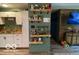 View of living space with an accent wall, wood floors, and modern shelving at 2650 Woodrow Ave, Indianapolis, IN 46241