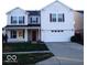 Charming two-story home with white siding, a two-car garage, and a cozy front porch at 2931 Sentiment Ln, Greenwood, IN 46143