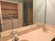 Bathroom with double sinks, large mirror, and view to closet and laundry area at 2996 Colony Lake W Dr, Plainfield, IN 46168