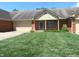 Inviting single-story home with brick facade, lush lawn, and an attached two car garage at 2996 Colony Lake W Dr, Plainfield, IN 46168