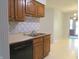 Functional kitchen featuring wood cabinets, stainless steel appliances, and blue patterned tiling at 2996 Colony Lake W Dr, Plainfield, IN 46168