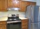 Well-lit kitchen features stainless steel appliances and oak cabinets at 2996 Colony Lake W Dr, Plainfield, IN 46168