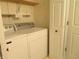 The laundry area has a washer, dryer, shelving, and storage space at 2996 Colony Lake W Dr, Plainfield, IN 46168