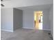 Open living room with neutral paint, plush carpet, and seamless transition to dining area at 2996 Colony Lake W Dr, Plainfield, IN 46168