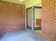 Enclosed brick patio featuring sliding screen door leading indoors at 2996 Colony Lake W Dr, Plainfield, IN 46168