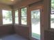 Cozy sunroom with brick walls, multiple windows, and a door to the outside at 2996 Colony Lake W Dr, Plainfield, IN 46168