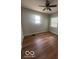 The bedroom has hardwood floors and a ceiling fan at 3026 S Rybolt Ave, Indianapolis, IN 46241