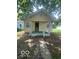 Charming bungalow featuring a covered porch and light yellow siding at 3026 S Rybolt Ave, Indianapolis, IN 46241