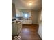 Bright kitchen with white cabinets and a window over the sink at 3026 S Rybolt Ave, Indianapolis, IN 46241