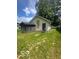 Back exterior featuring an outbuilding and grassy yard at 3026 S Rybolt Ave, Indianapolis, IN 46241