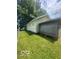 Home's side yard featuring green grass and a shed at 3026 S Rybolt Ave, Indianapolis, IN 46241