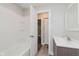Well-lit bathroom featuring modern fixtures, a tub, and wood-look flooring at 3149 Thayer St, Indianapolis, IN 46222