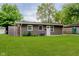 Well-kept home with manicured lawn and tidy landscaping, featuring a neutral-colored exterior at 3149 Thayer St, Indianapolis, IN 46222