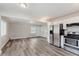 Bright, open kitchen with stainless steel appliances, white cabinets, and wood-look flooring at 3149 Thayer St, Indianapolis, IN 46222