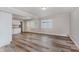 Spacious living area with hardwood floors, neutral paint, and adjoining kitchen at 3149 Thayer St, Indianapolis, IN 46222